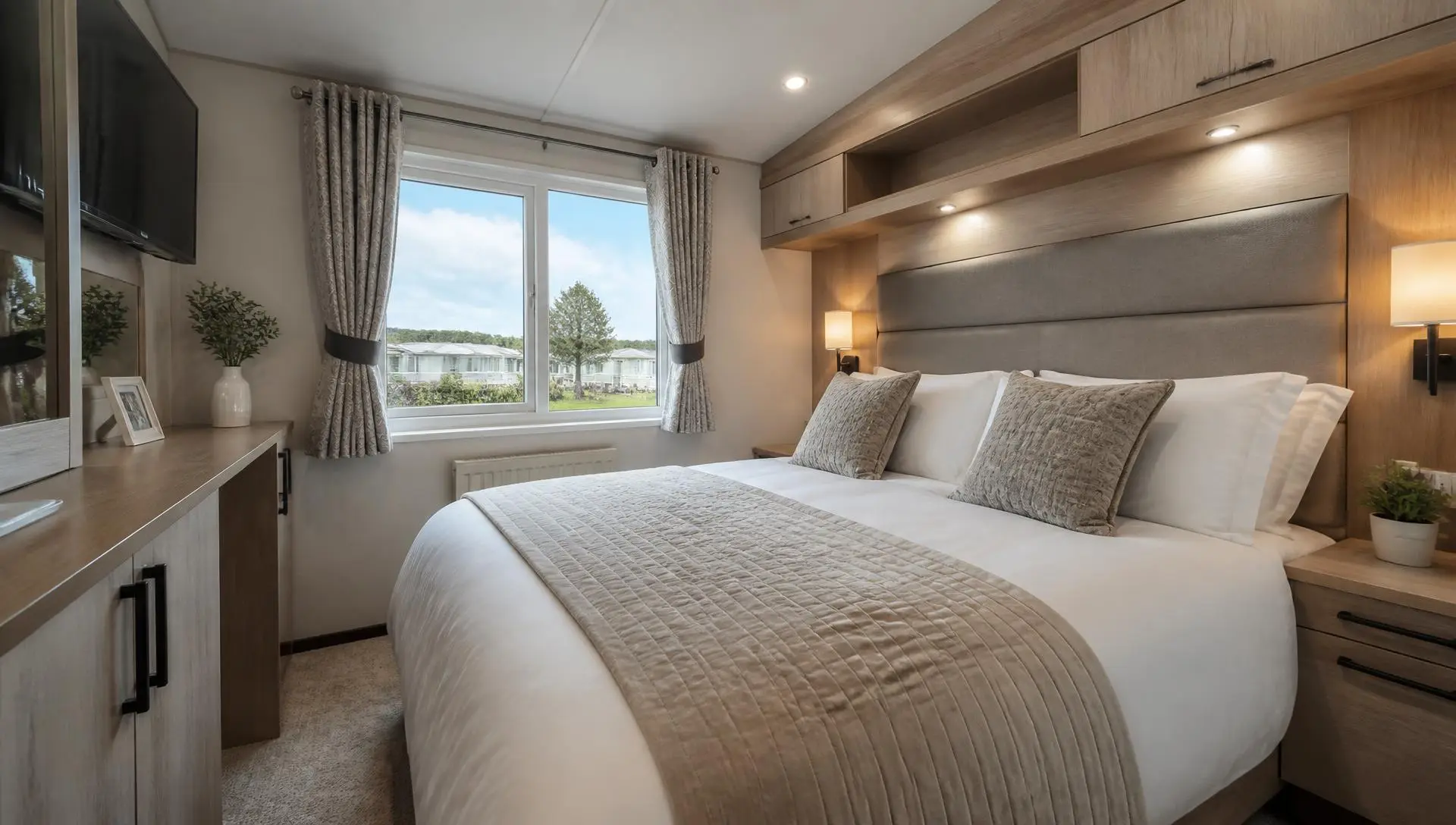 Modern static caravan bedroom with a made-up double bed