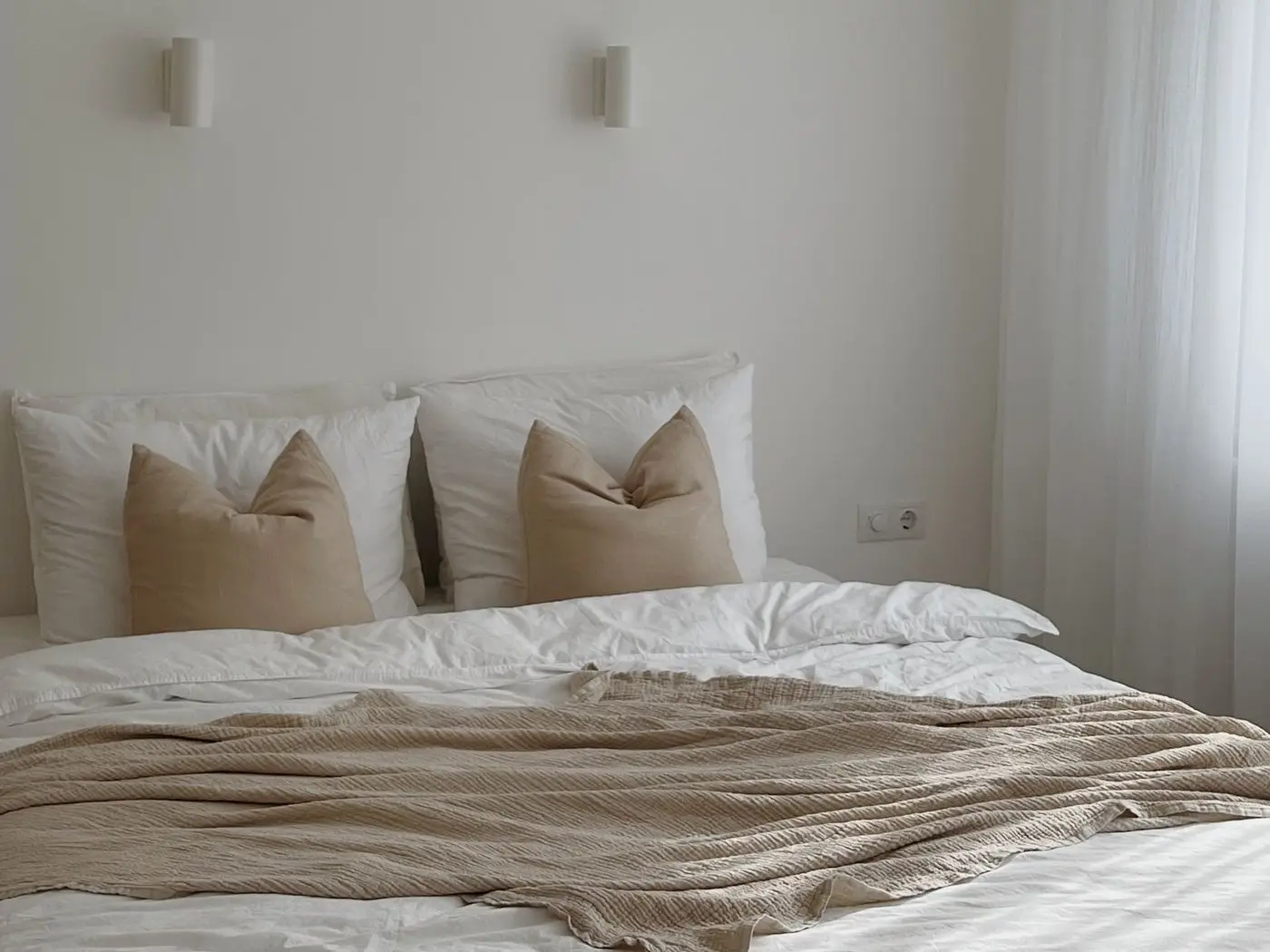 Bed made up with a quality mattress and neutral bedding