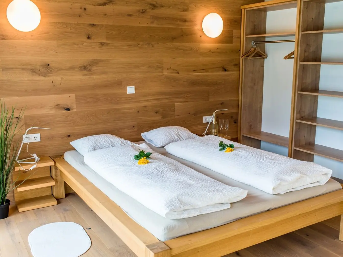Twin single beds in a timber-lined holiday accommodation bedroom